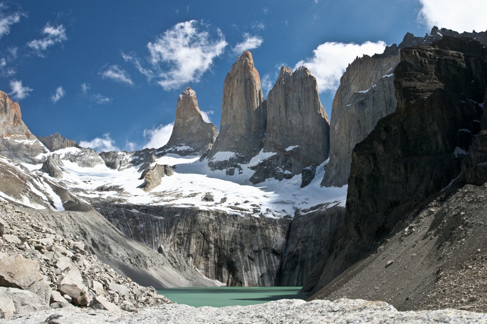 The iconic Torres del Paines or “Towers of Blue” guard the turquoise lake at their rocky foothills.