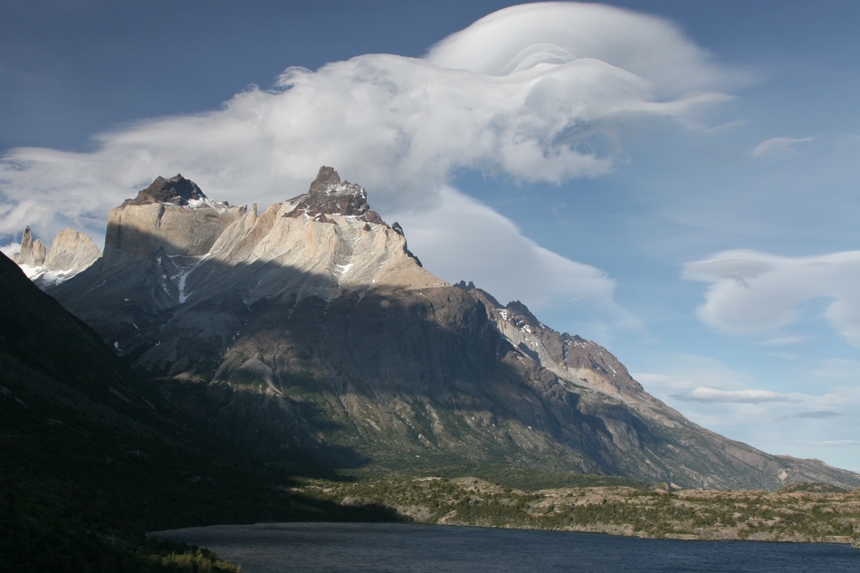 Clouds swirl in the strong winds over the Paine Massif, mimicking the shapes of the peaks.